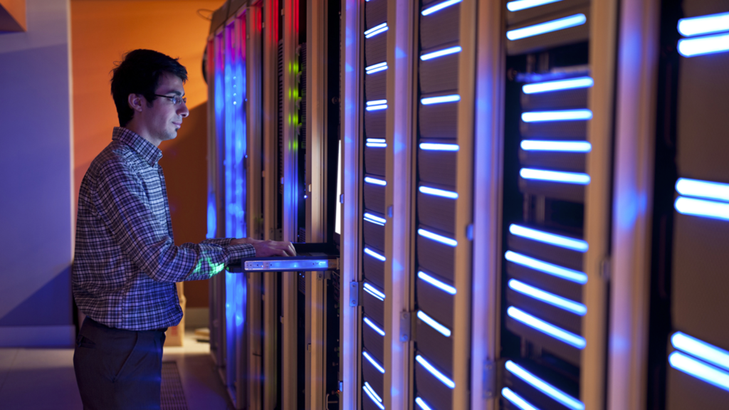 A man standing in a server room.