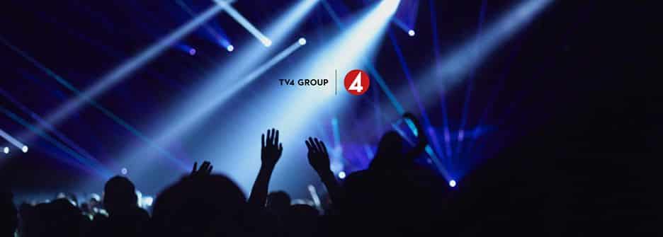 A crowd of people silhouetted against white and blue beams of light at a concert. TV4 Group's logo is at the center of the image.