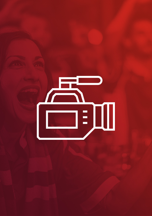 An icon of a film camera. The icon is set against a red-tinged background featuring a smiling woman wearing a striped scarf and looking up.