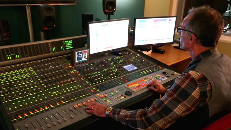 Man sitting at a mixing desk.