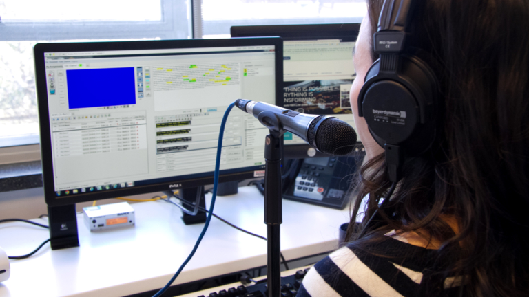 A woman creating subtitles through respeaking.