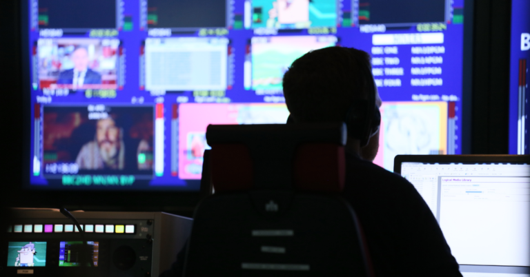 Person sitting at a computer screen in Playout suite.
