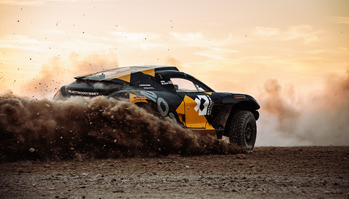 A rally car kicking up dirt.
