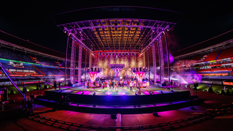 A show on a stage in the centre of a stadium.