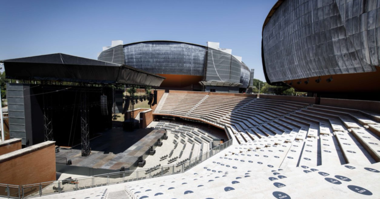 An outdoor auditorium facing a stage.