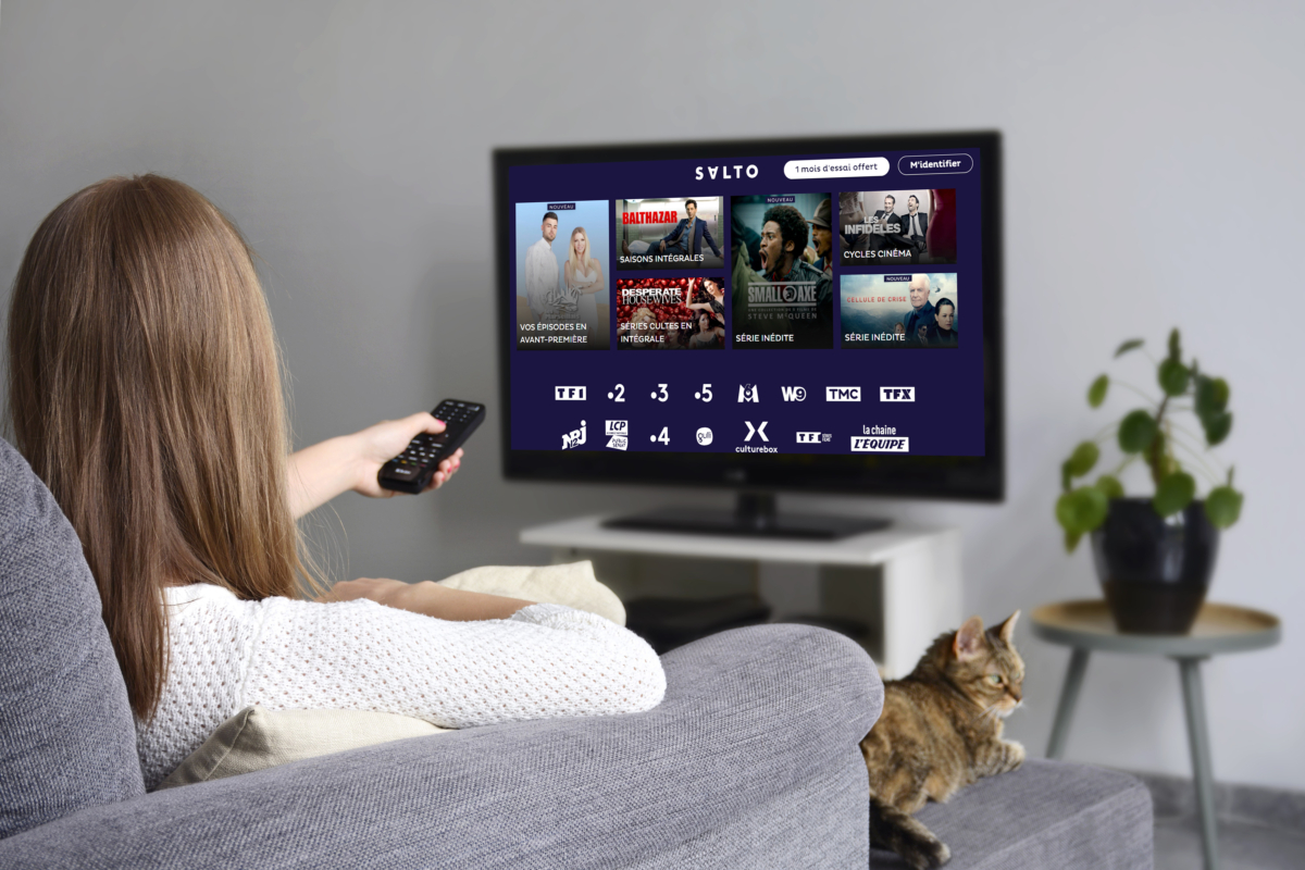 A woman selecting a programme on a streaming service.