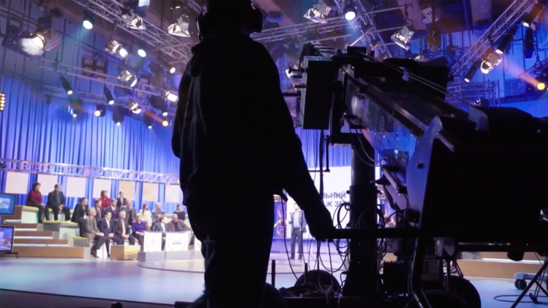 A camera operator filming a talk show.