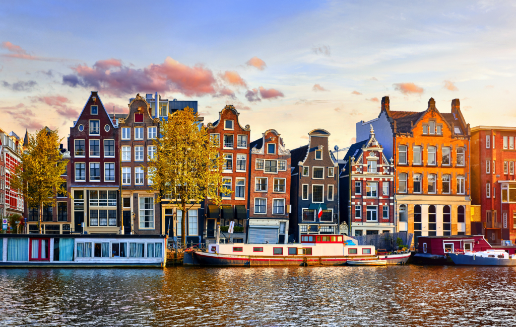 A row of tall, narrow, crooked houses overlooking a canal.