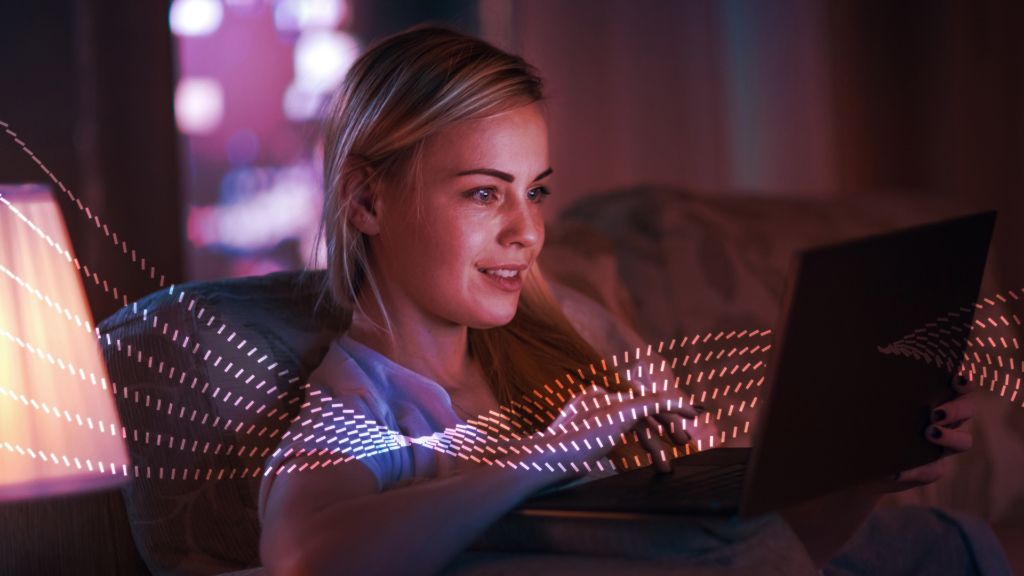Six red-and-white, dotted lines passing in front of a woman watching something on a laptop.