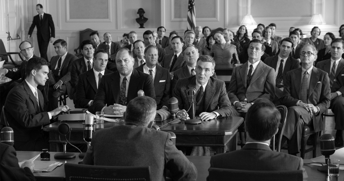 A black and white image of men in suits from the film Oppenheimer.